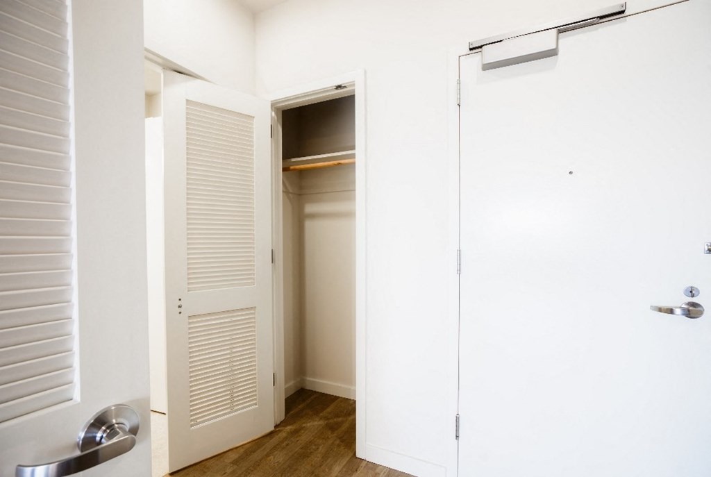 an empty closet in a bathroom with a sliding door