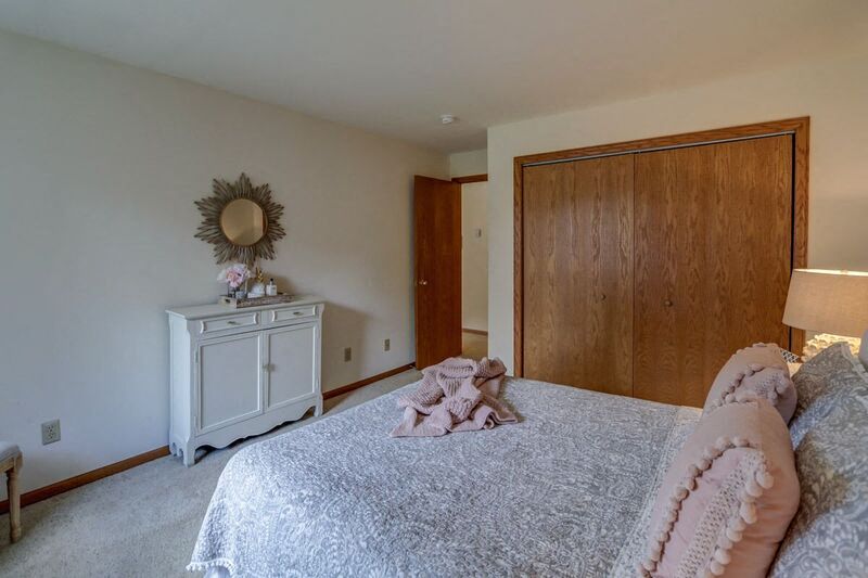 a bedroom with a large bed and a white dresser