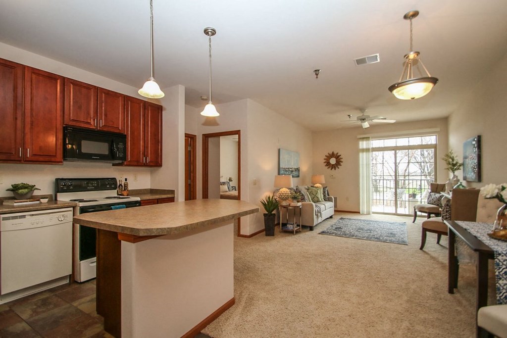 a kitchen with a counter top and a living room