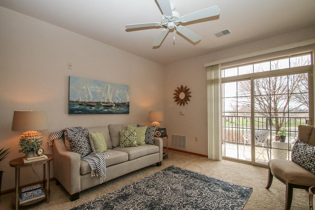 a living room with a couch and a ceiling fan