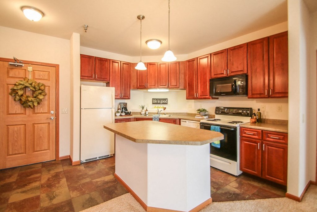 a kitchen with wooden cabinets and a counter top