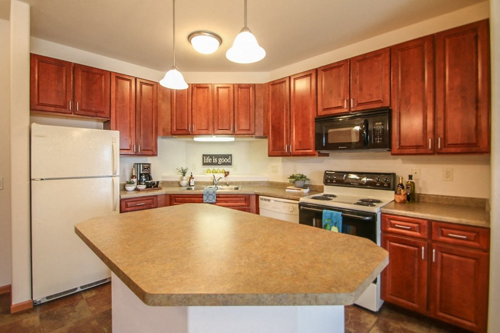 a kitchen with wooden cabinets and a counter top