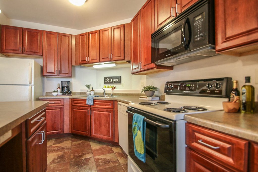 a kitchen with wooden cabinets and stainless steel appliances
