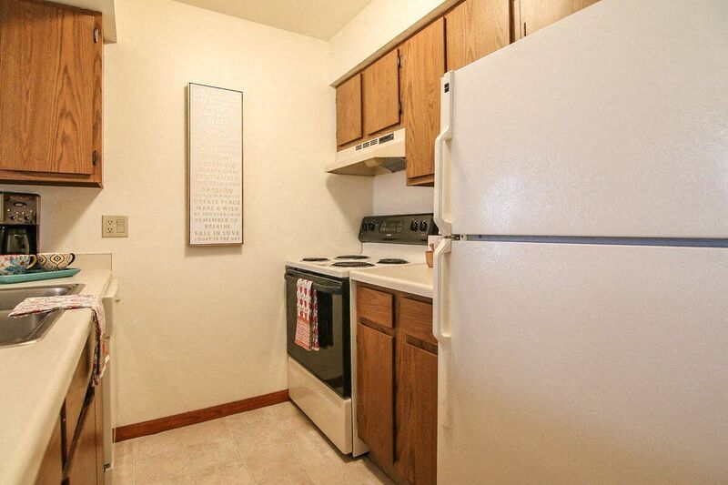 a kitchen with a white refrigerator and a stove