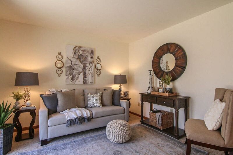 a living room with a couch and a mirror