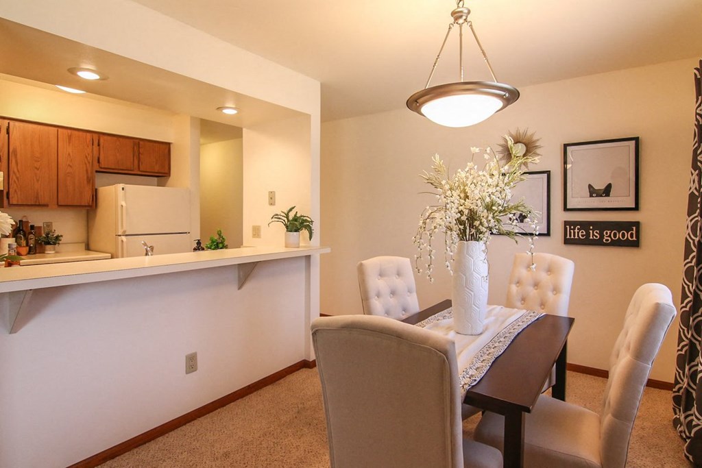 a dining room with a table and chairs