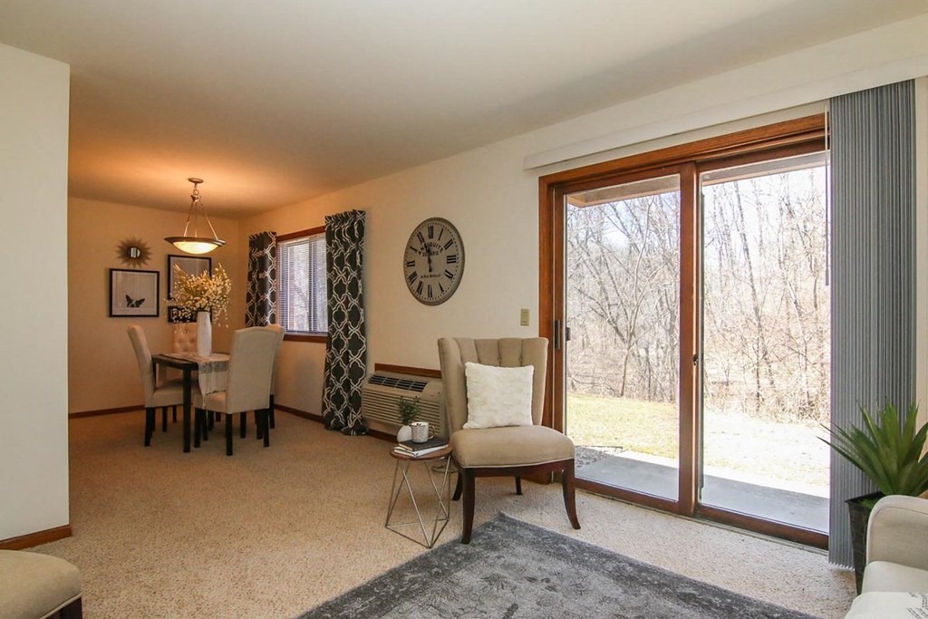 a living room and dining room with a large window