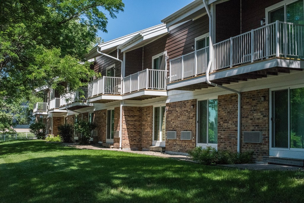 our apartments have a large yard with grass and trees