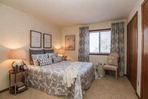 a bedroom with a large bed and a window