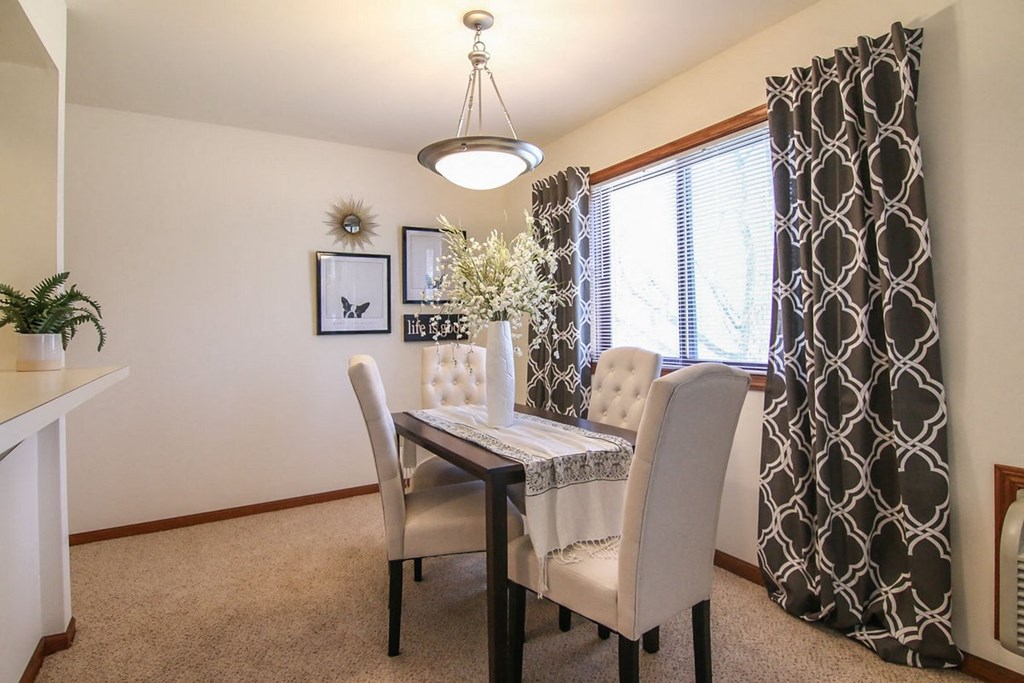 an image of a dining room with a table and chairs