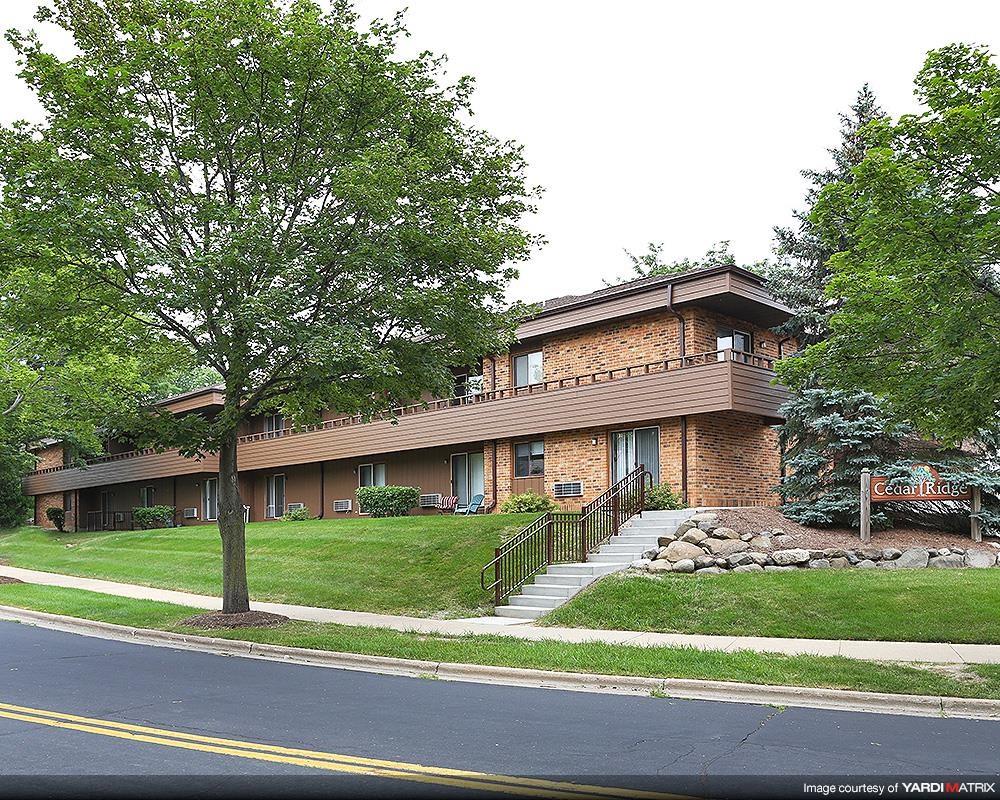 a house with stairs and a tree in front of it