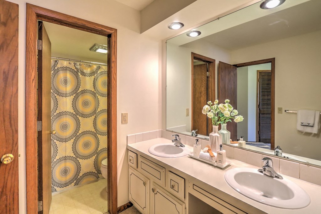 a bathroom with two sinks and a large mirror