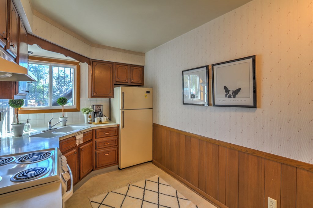 a kitchen with a stove and a refrigerator