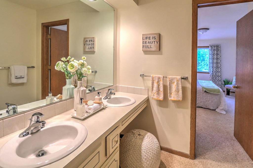 a bathroom with two sinks and a mirror