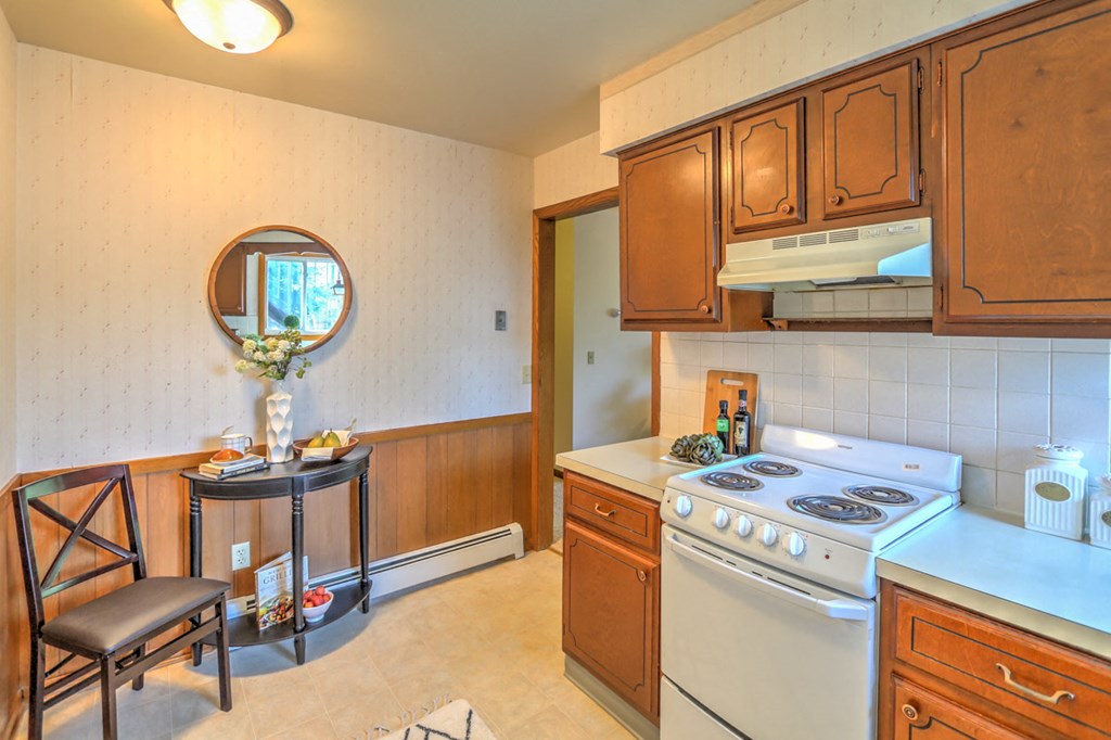 a kitchen with white appliances and wooden cabinets