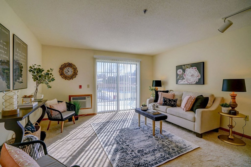 a living room with furniture and a sliding glass door