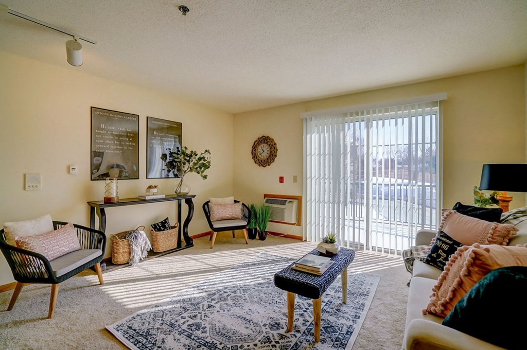 a living room with furniture and a sliding glass door