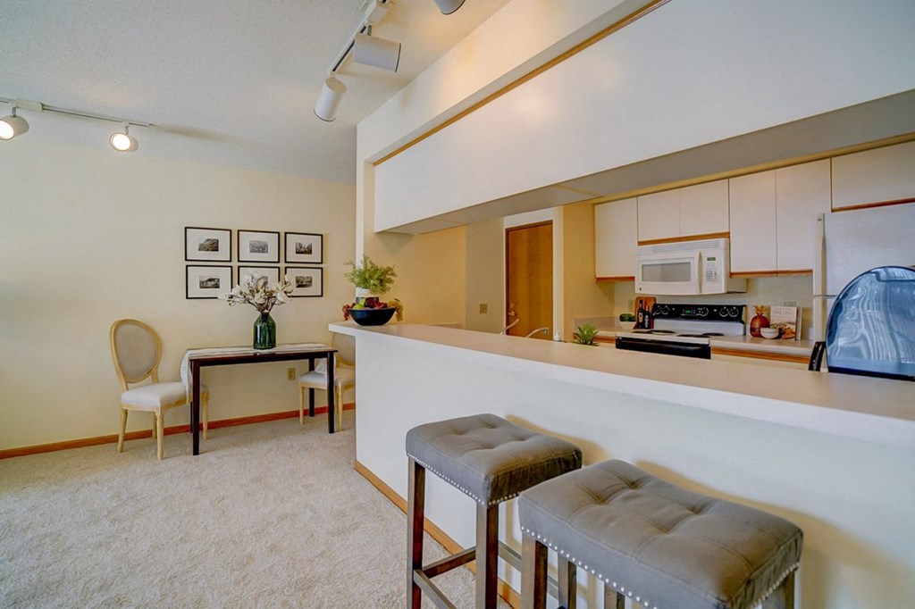 a living room with a bar and a kitchen