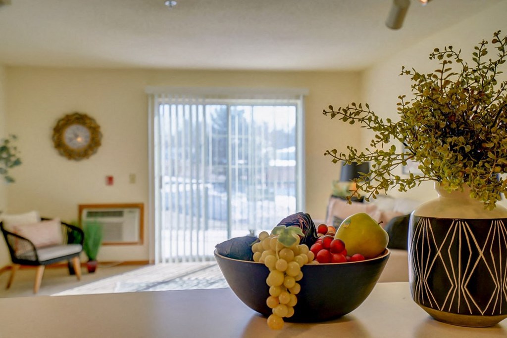 a living room with a bowl of fruit on a table