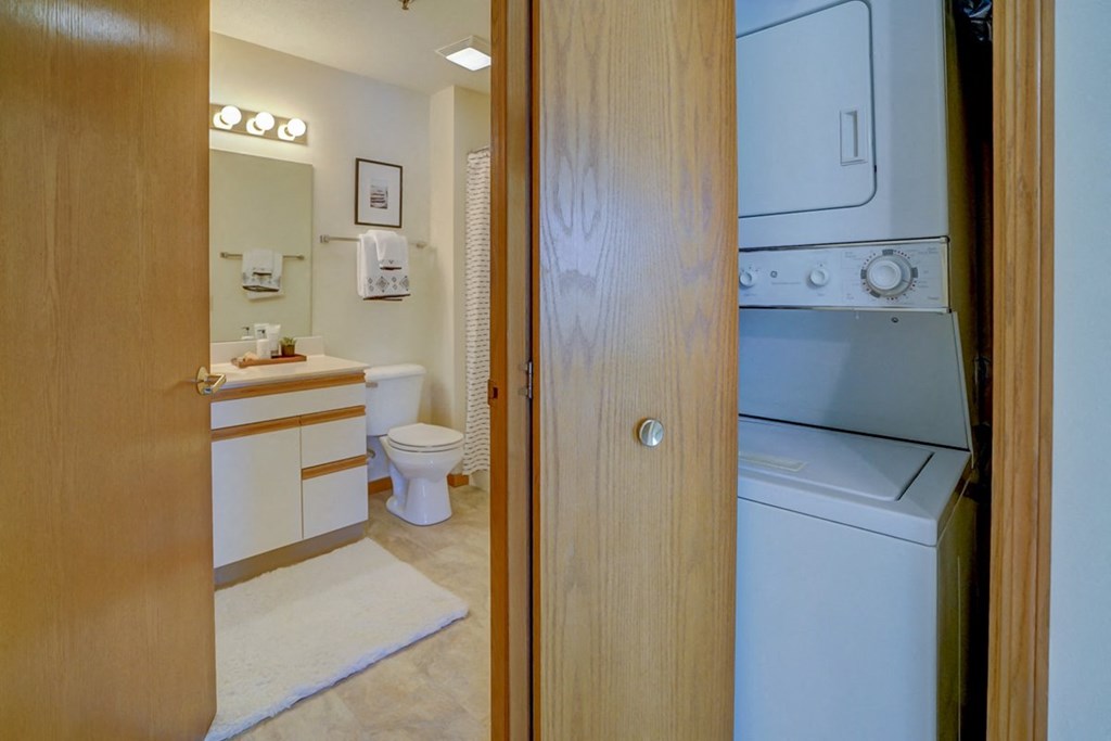 a view of a bathroom with a washer and dryer in it