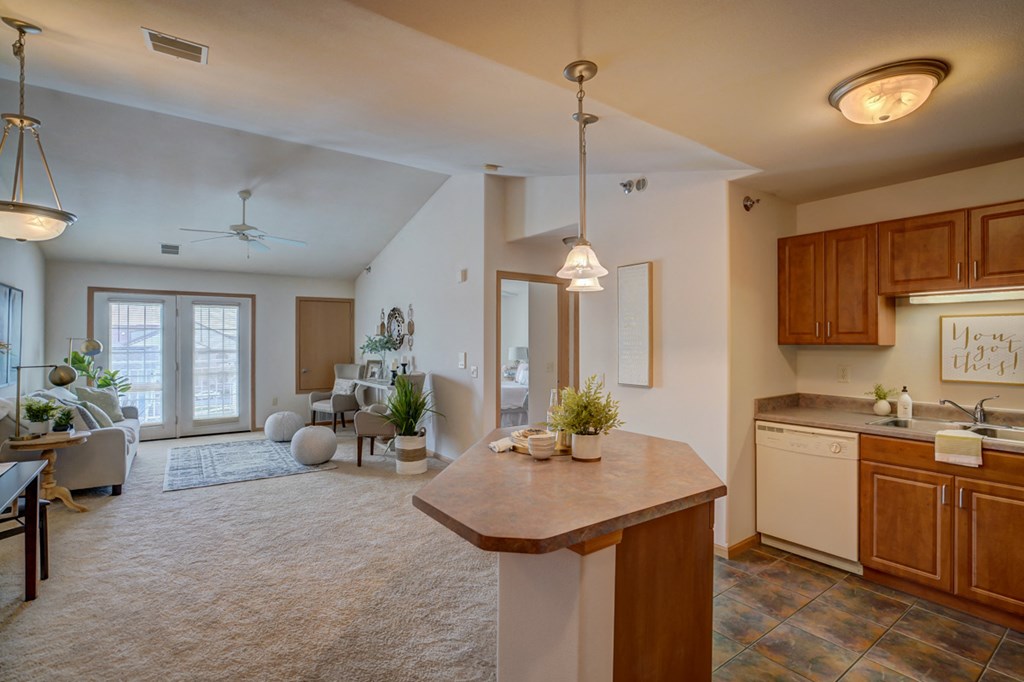 the view of a living room and kitchen from the dining room of a home