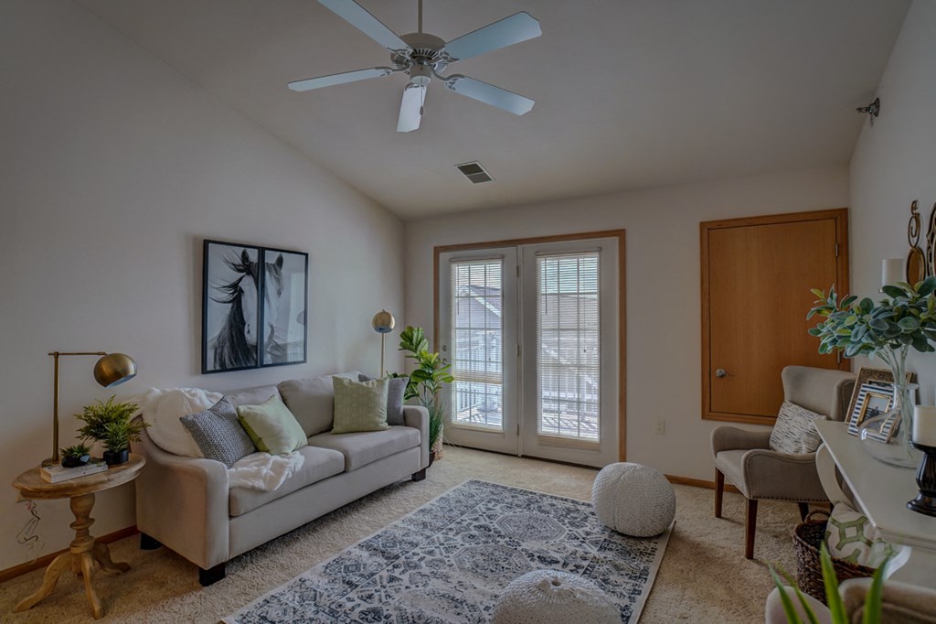 a living room with a couch and a ceiling fan