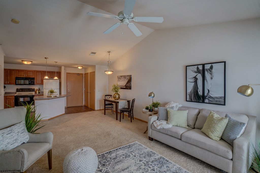 a living room with a couch and a ceiling fan