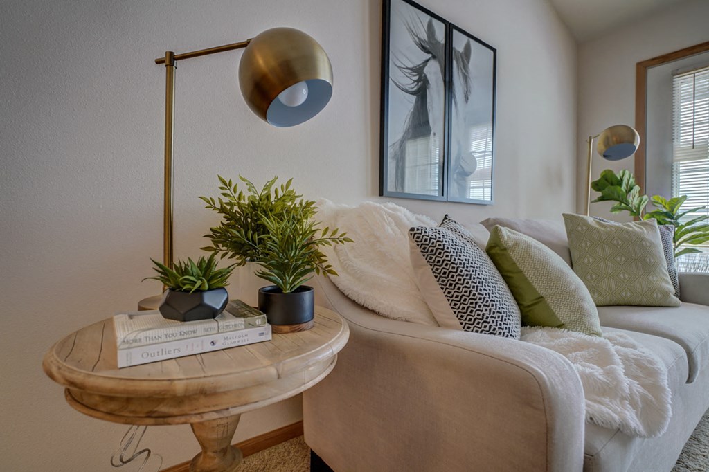 a living room with a couch and a table with plants