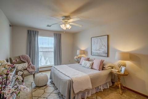 a bedroom with a bed and a ceiling fan