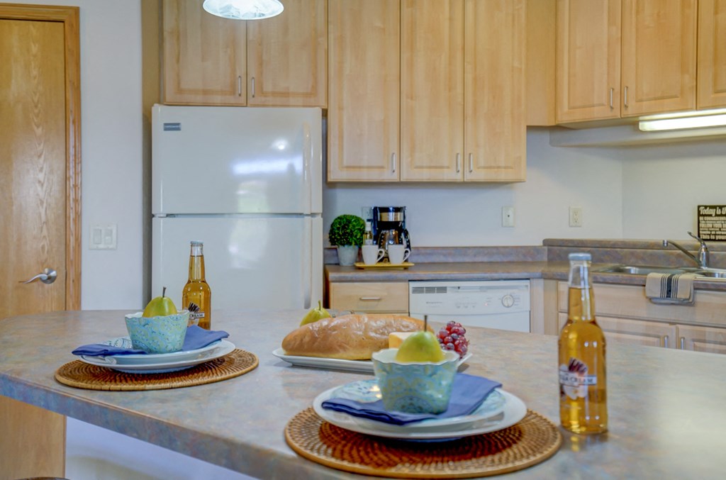 a kitchen with a counter with plates of food on it