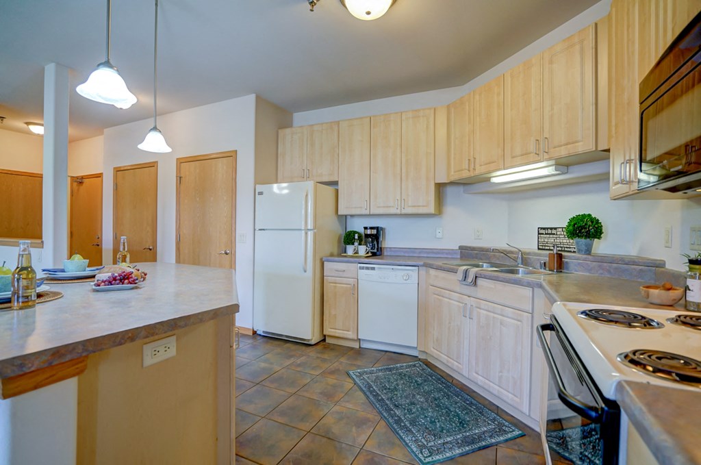 a kitchen with white appliances and wooden cabinets