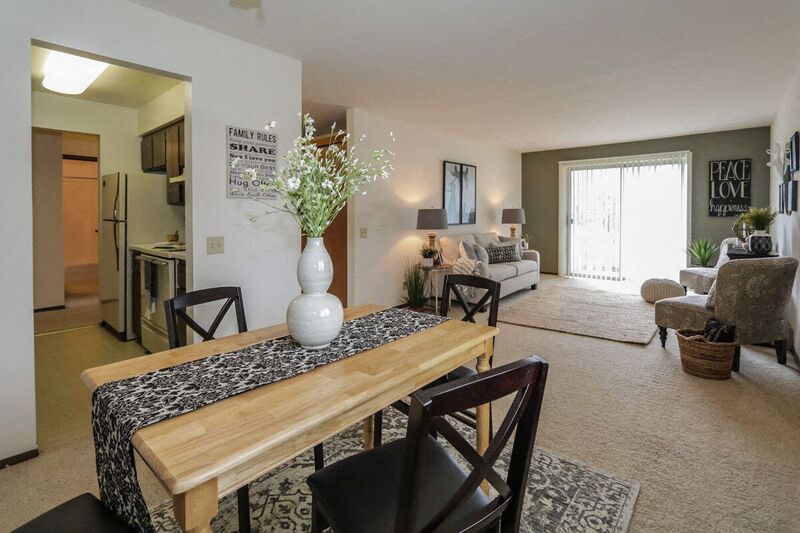 a living room with a table with a vase on it
