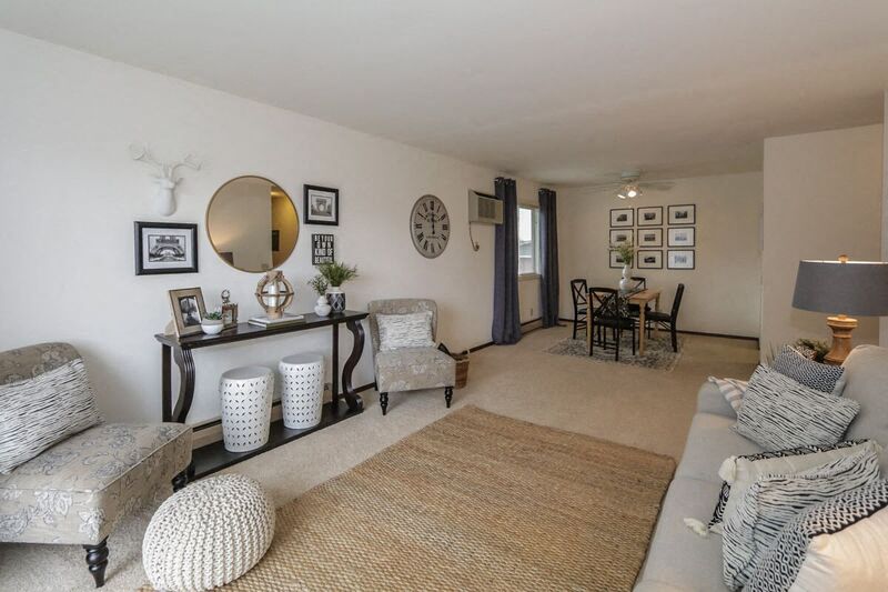 a living room with a couch and chairs and a table