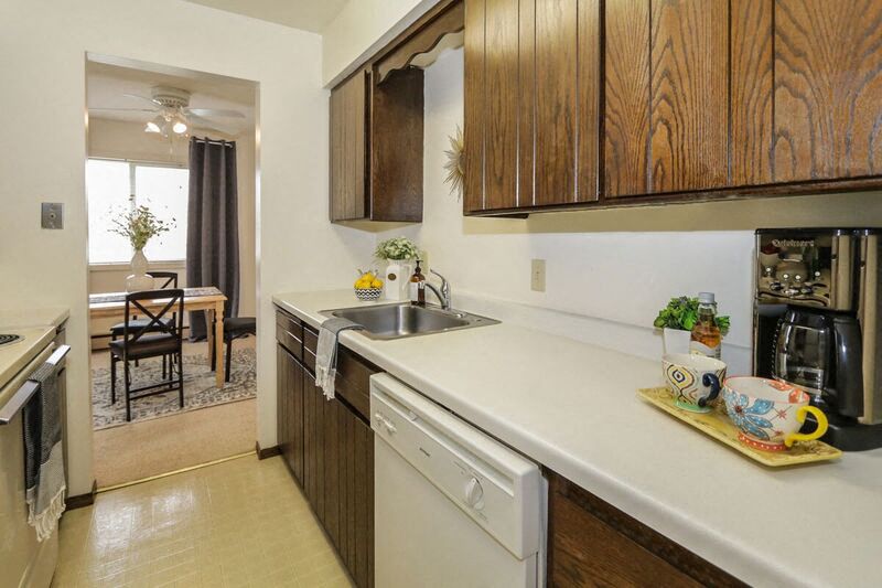 a kitchen with wooden cabinets and a sink