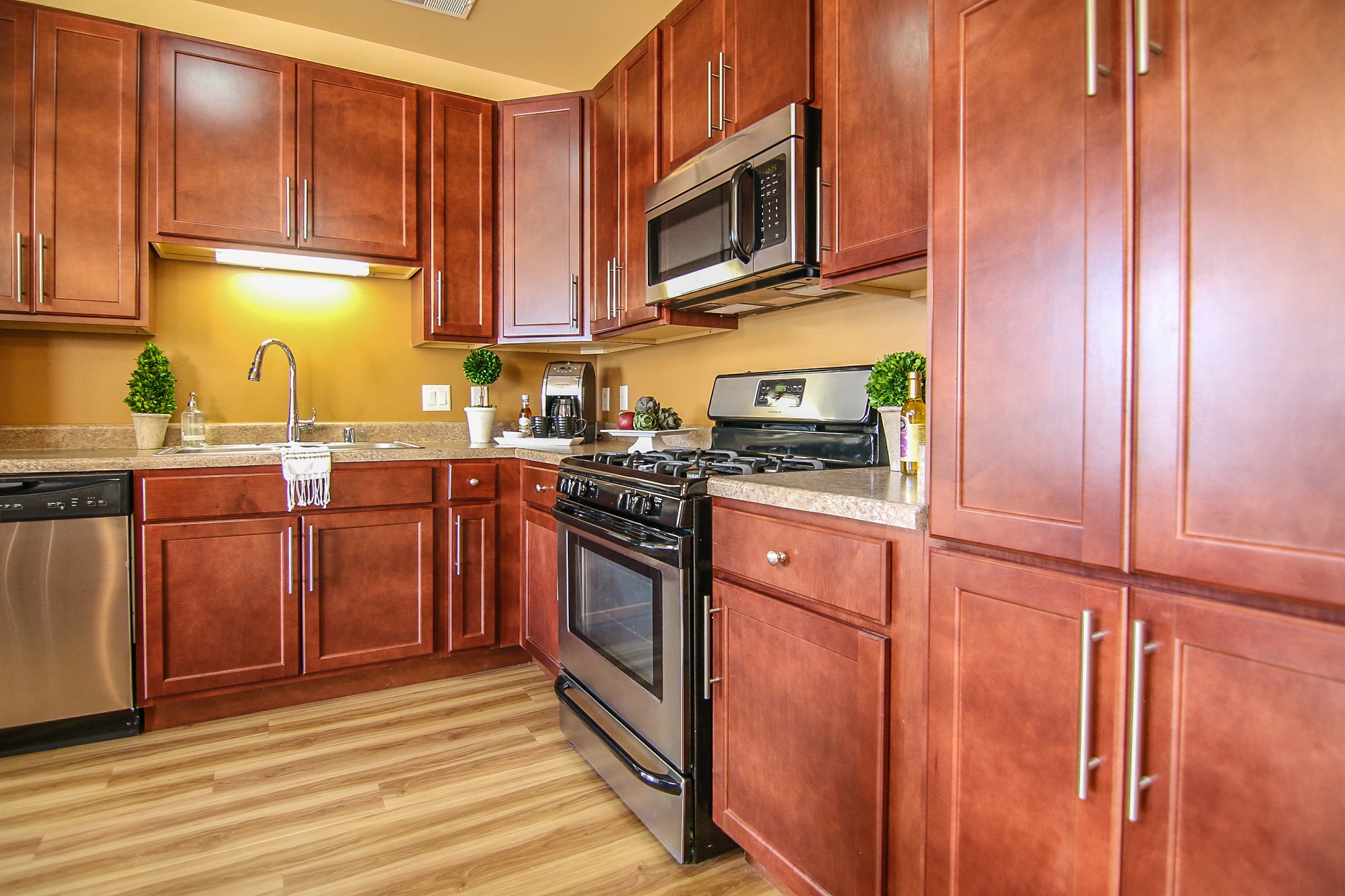 a kitchen with wooden cabinets and stainless steel appliances