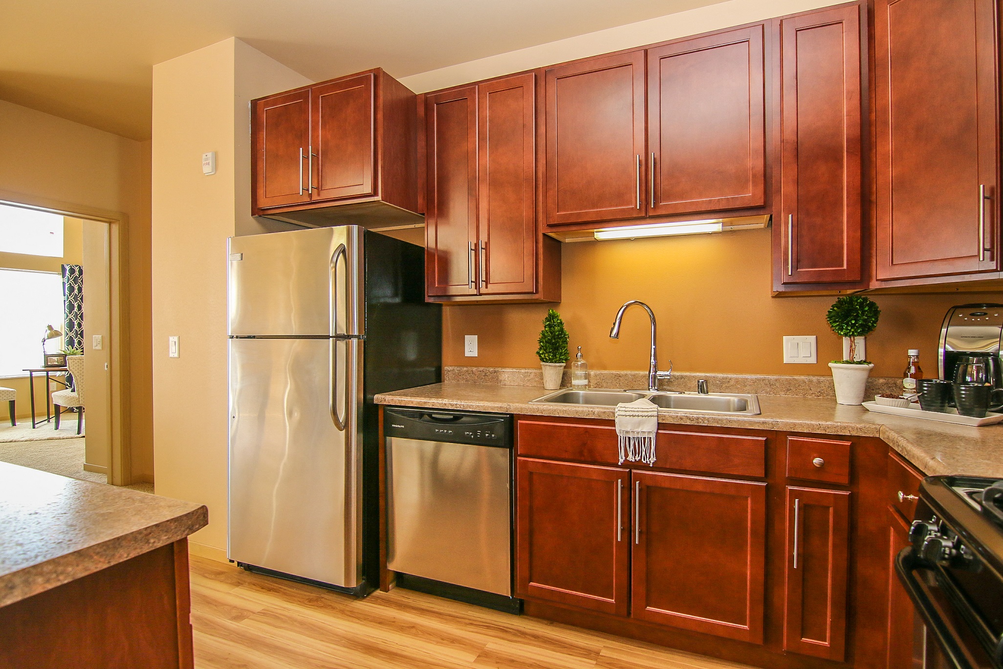 a kitchen with stainless steel appliances and wooden cabinets