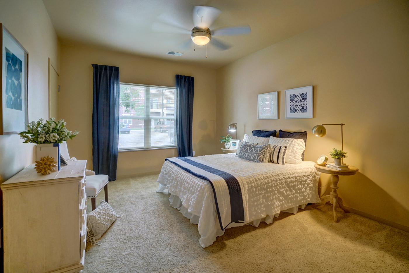 a bedroom with a bed and a ceiling fan