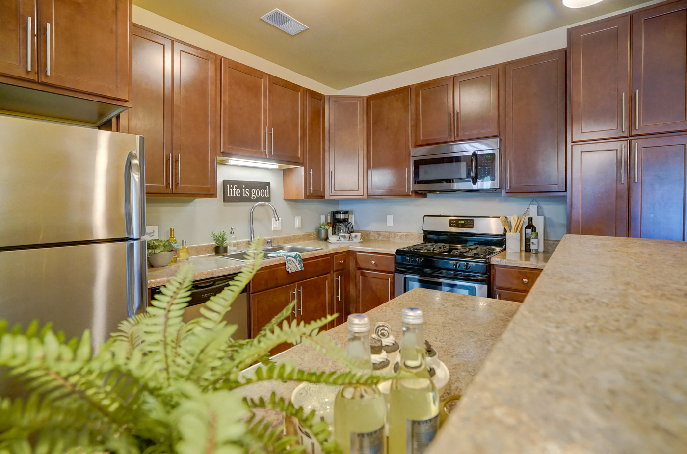 a kitchen with wooden cabinets and stainless steel appliances