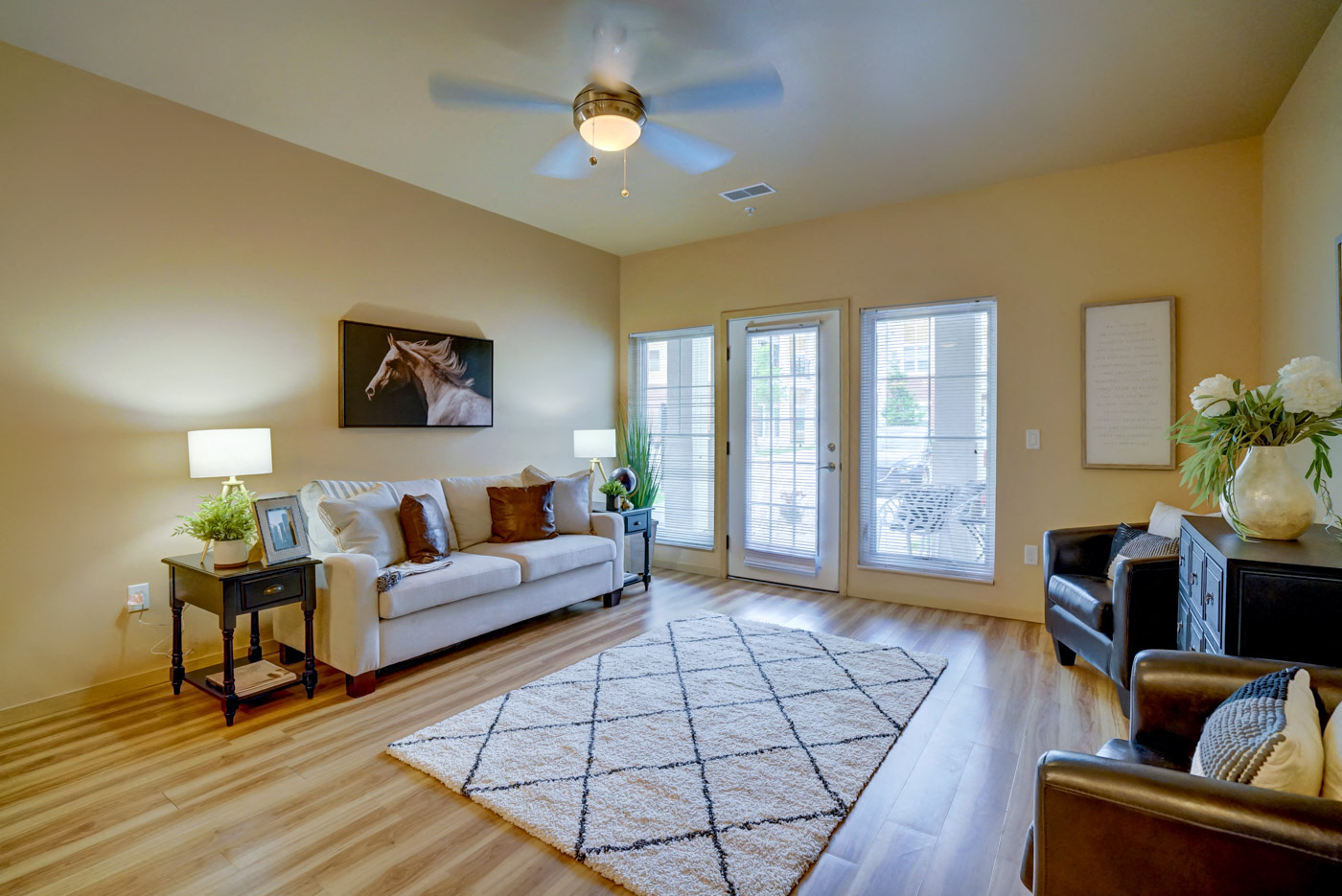 a living room with a couch and a ceiling fan
