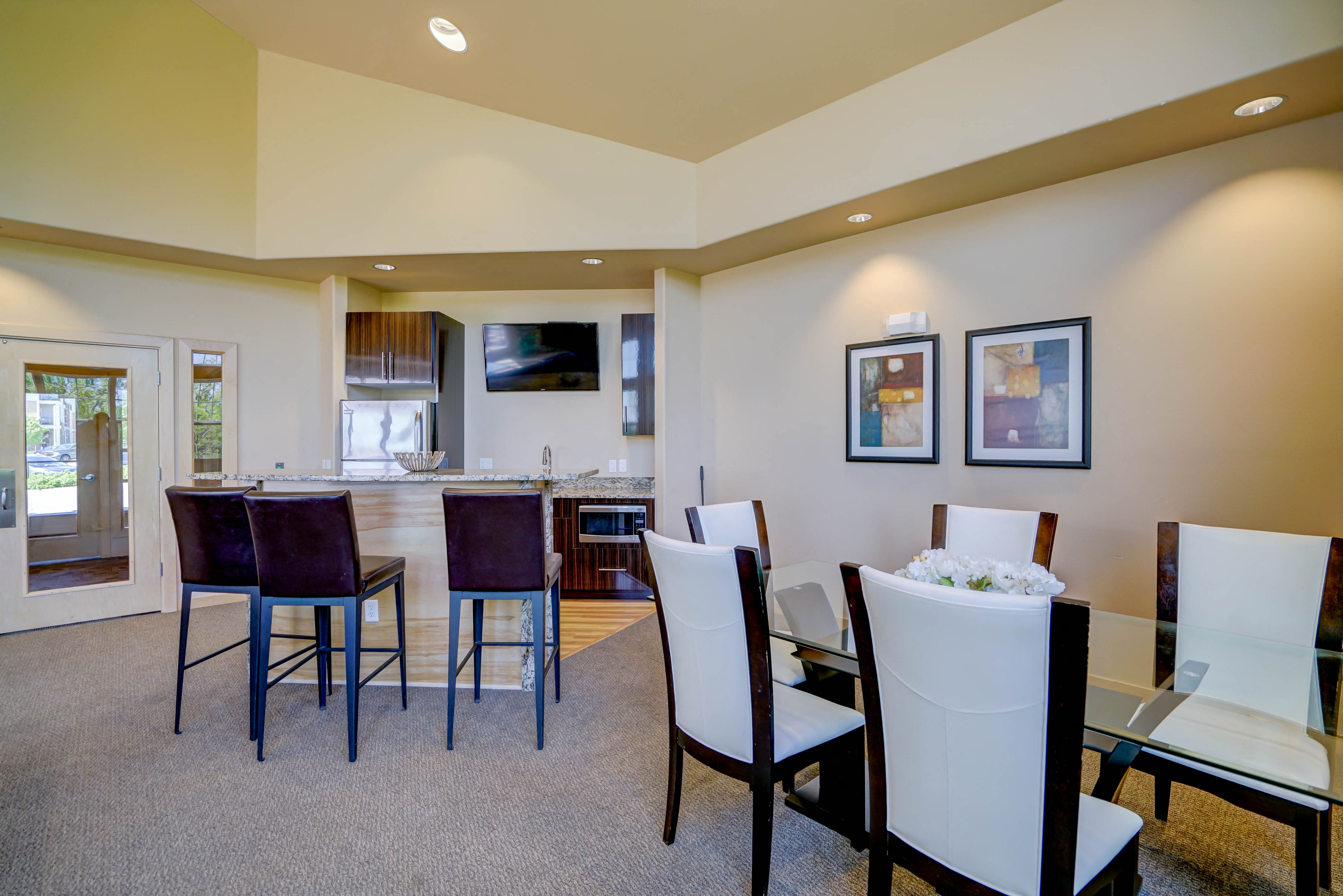 a dining room with a table and chairs and a kitchen