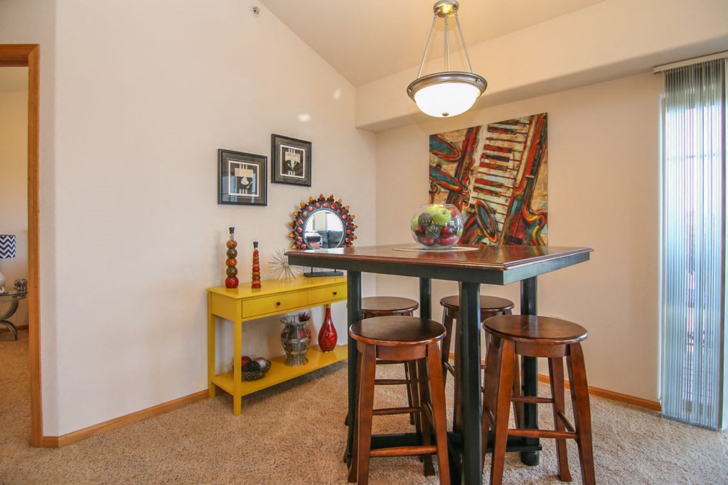 a dining room with a table and three stools