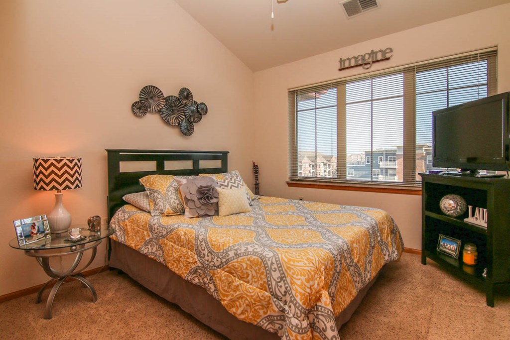 a bedroom with a bed and a television