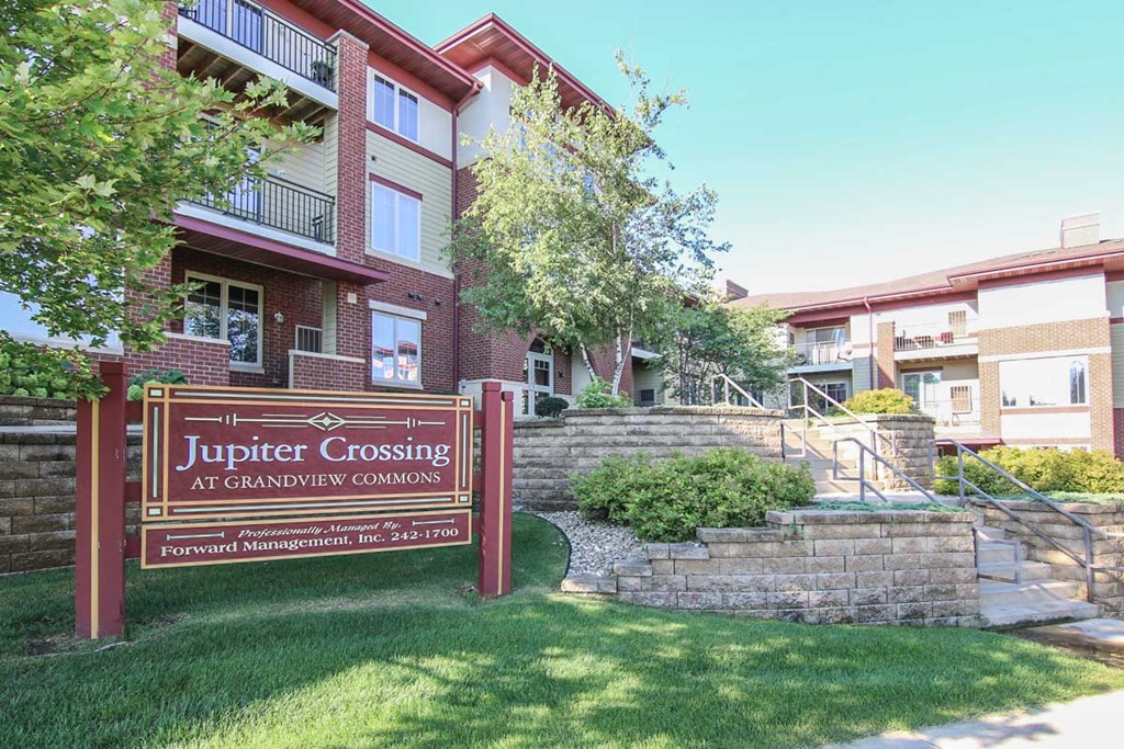 an apartment building with a jupiter crossing sign in front