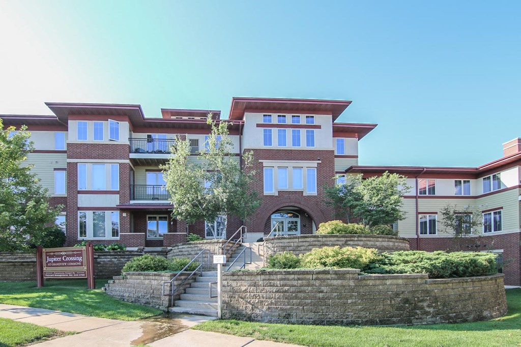 a large brick building with a sign in front of it