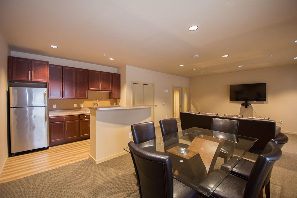 a kitchen and dining room with a table and chairs