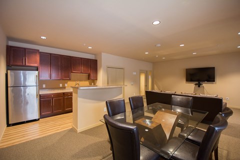 a kitchen and dining room with a table and chairs