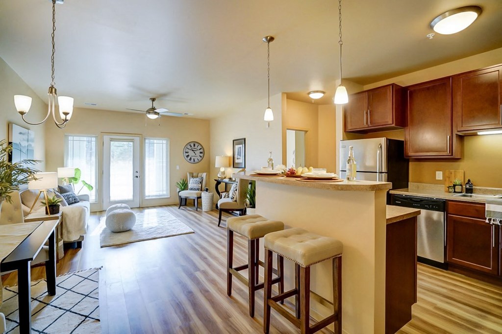 a kitchen with a bar and a living room