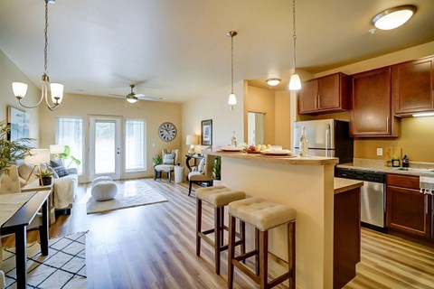 a kitchen with a bar and a living room