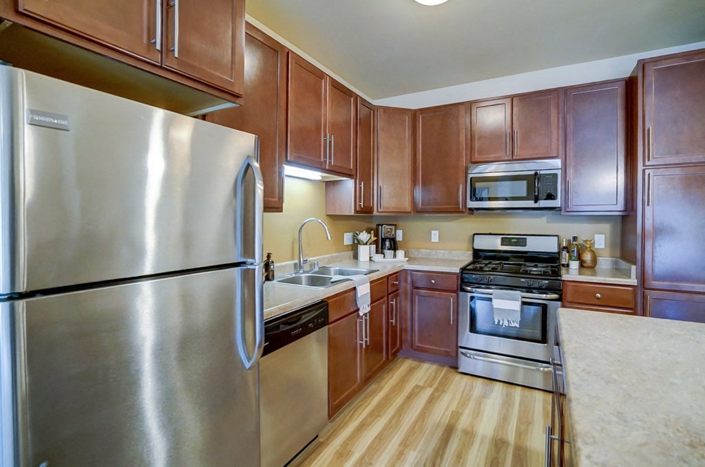 a kitchen with stainless steel appliances and wooden cabinets