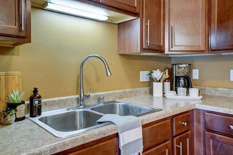 a kitchen with a sink and wooden cabinets